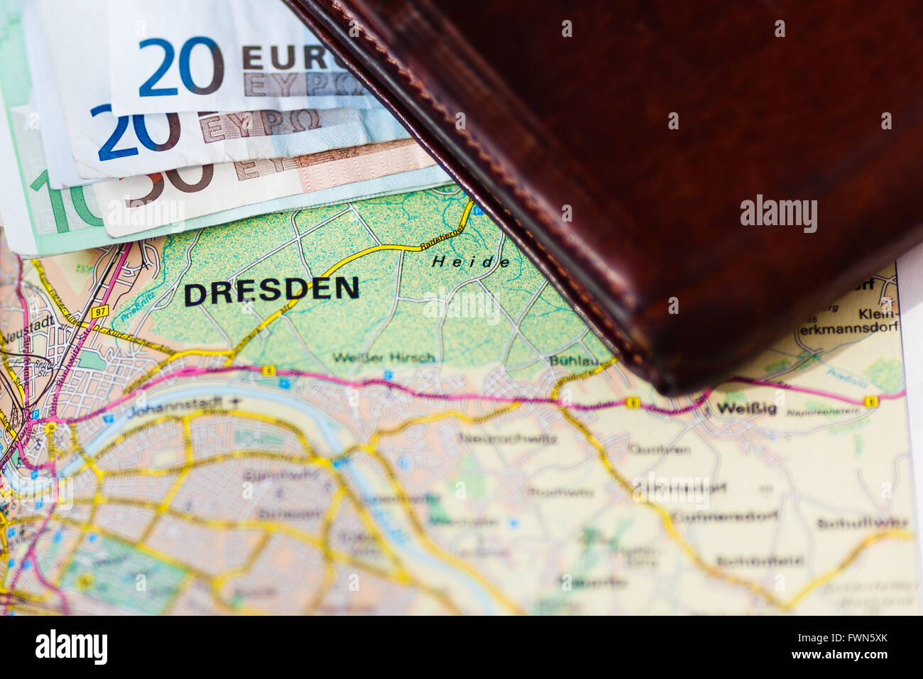 Euro banknotes inside wallet on a geographical map of Dresden, Germany Stock Photo