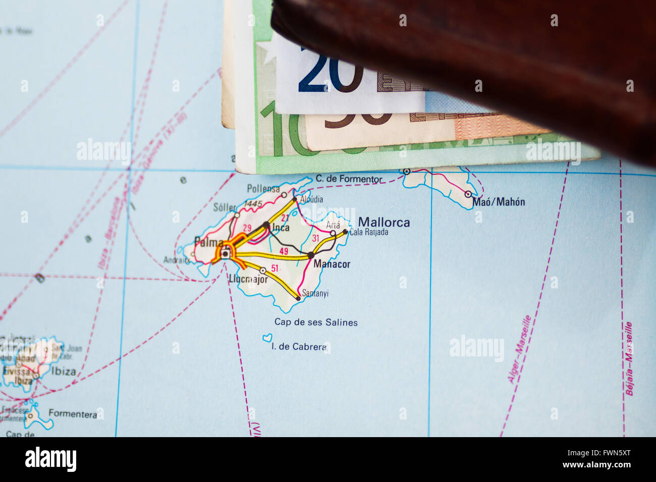 Euro banknotes inside wallet on a geographical map of Palma de Mallorca, Spain Stock Photo