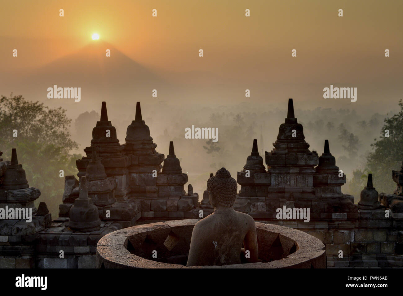 Sunrise over the Merapi volcano at Borobudur Temple Stock Photo