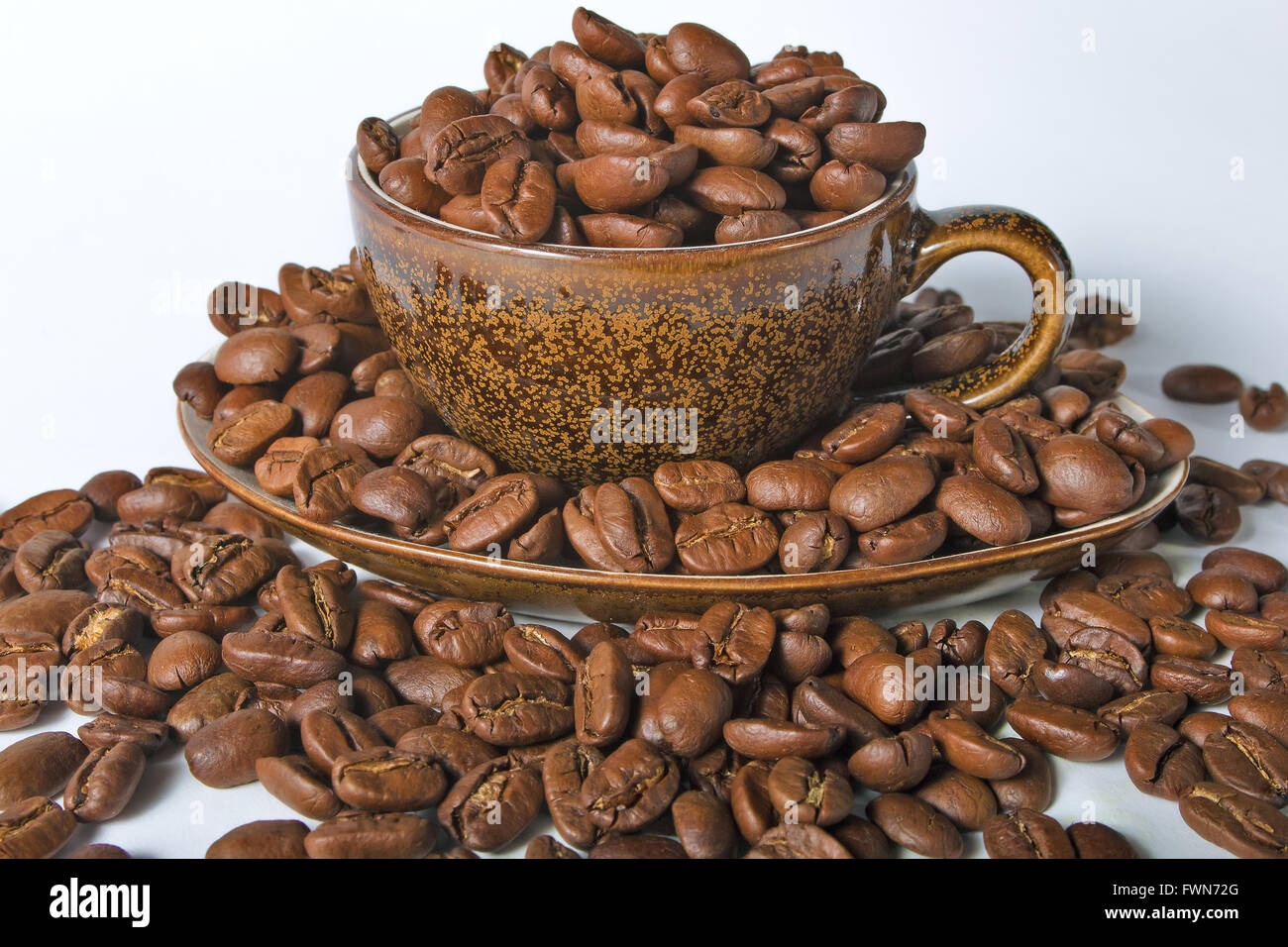 Coffee cup and beans on a white background Stock Photo - Alamy