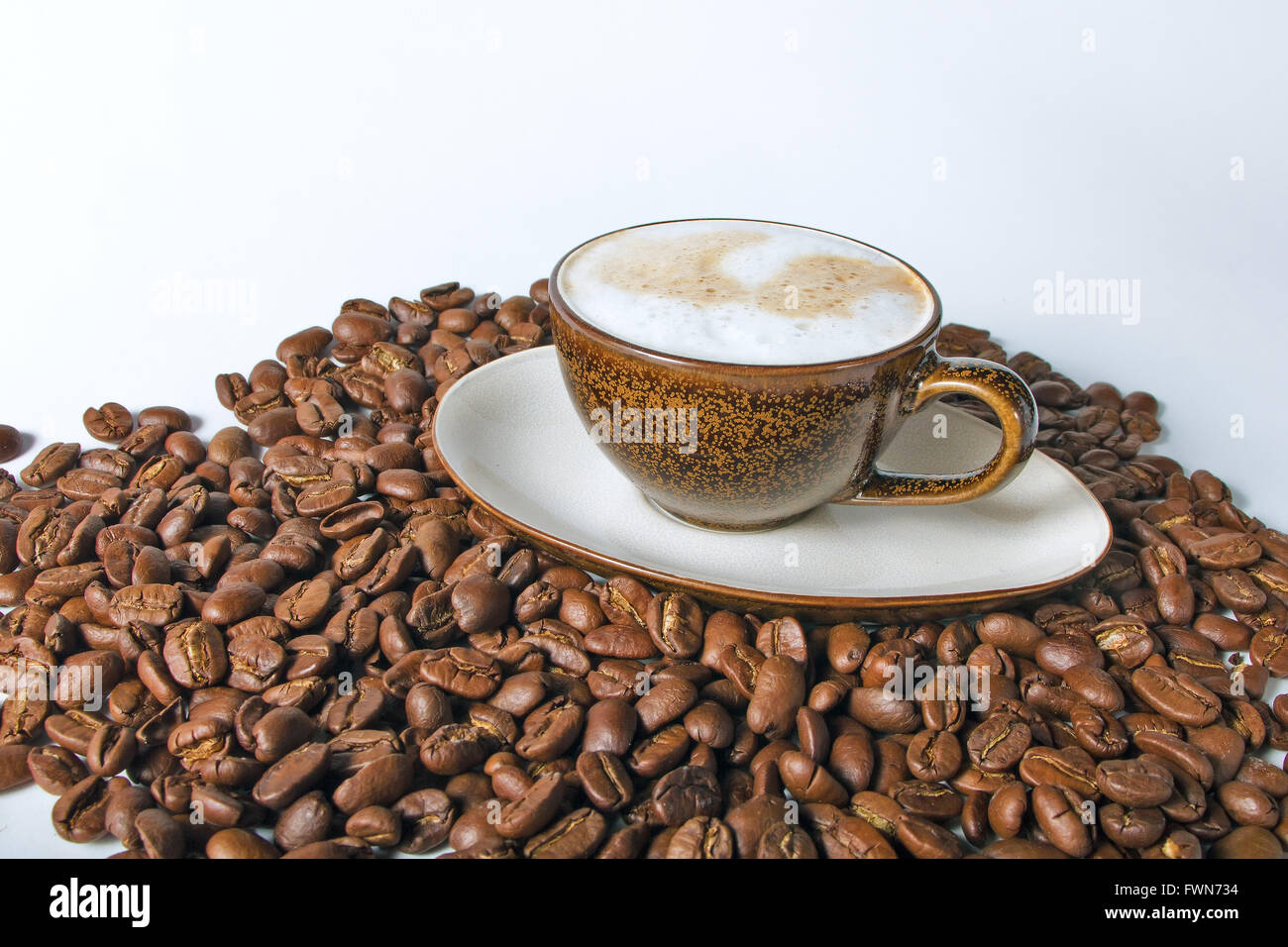 Coffee cup and beans on a white background Stock Photo - Alamy