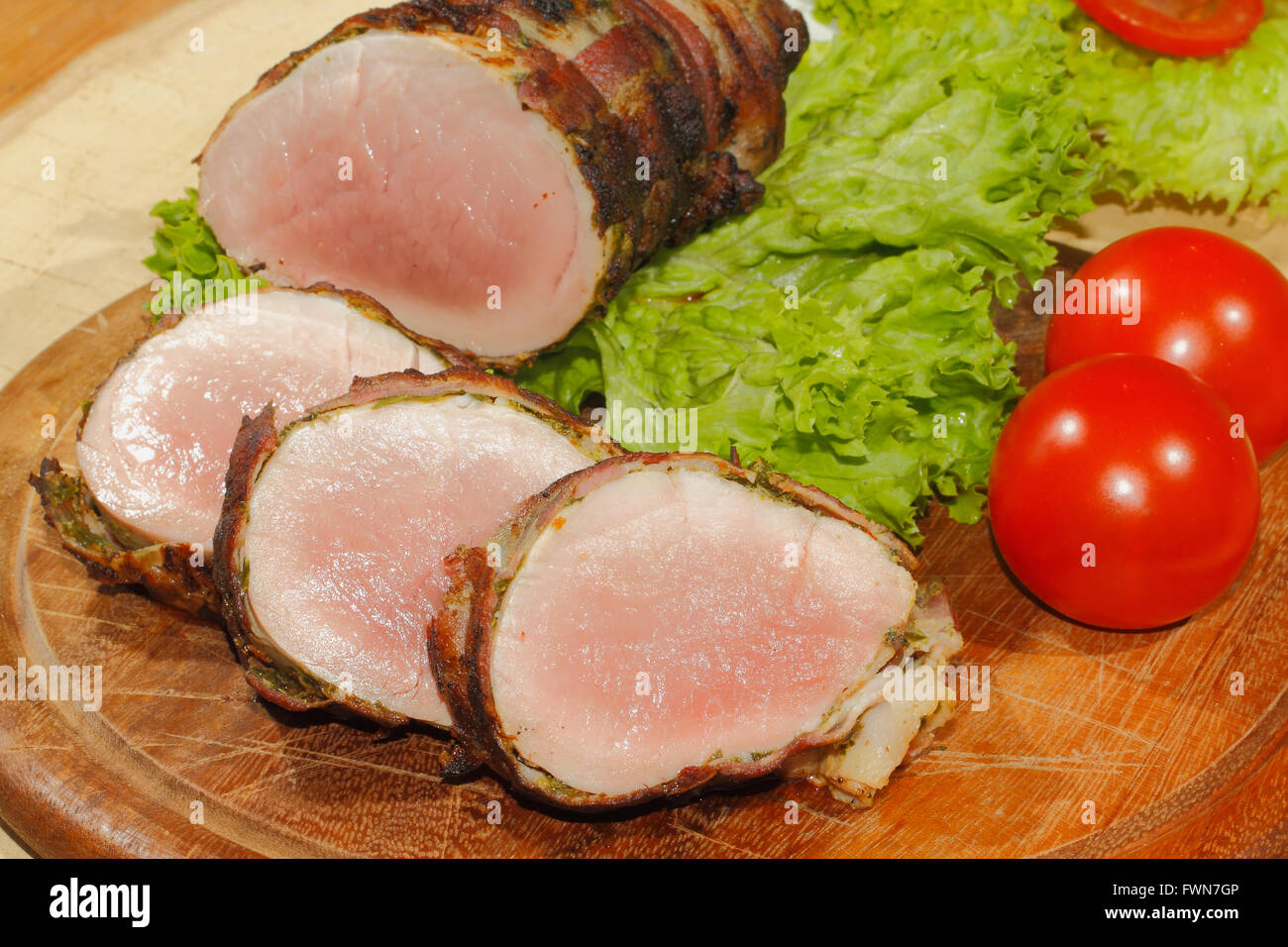 Pork tenderloin medallions meat wrapped in bacon grilled and