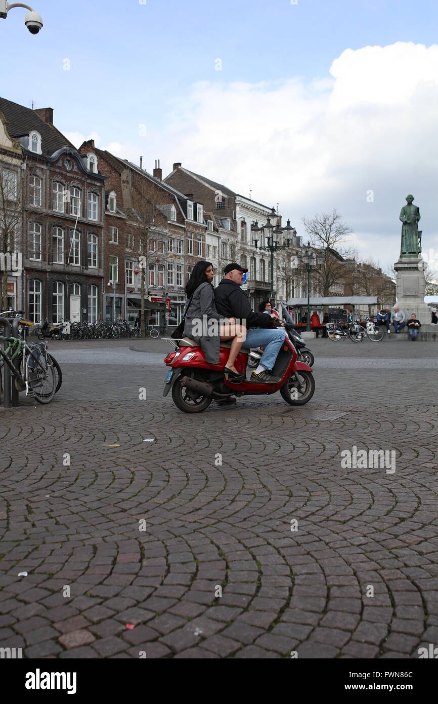 Maastricht, Netherlands. Couple on a red scooter, Markt place, crop