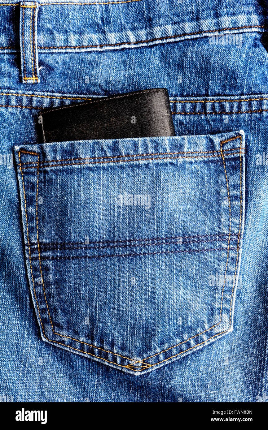 Denim jeans pocket with wallet poking out. Stock Photo