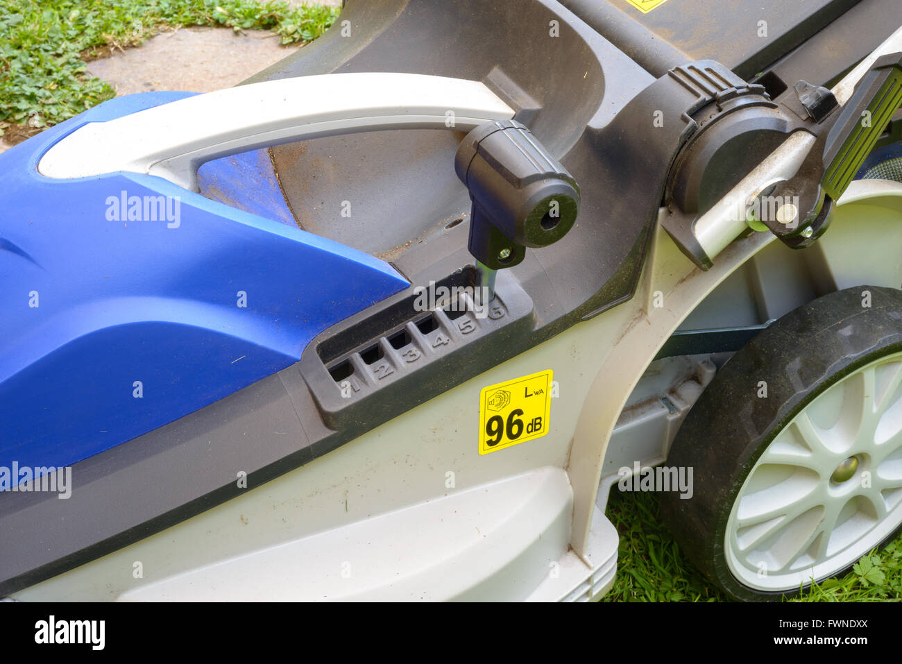 Blue Lawnmower in a garden during the work Stock Photo - Alamy