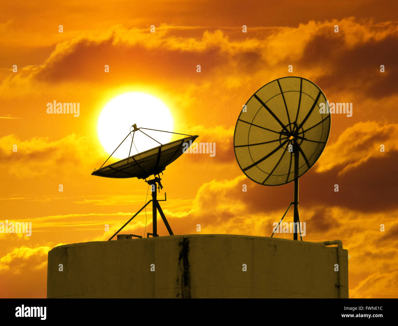 Two satellite disk and sunset Stock Photo - Alamy