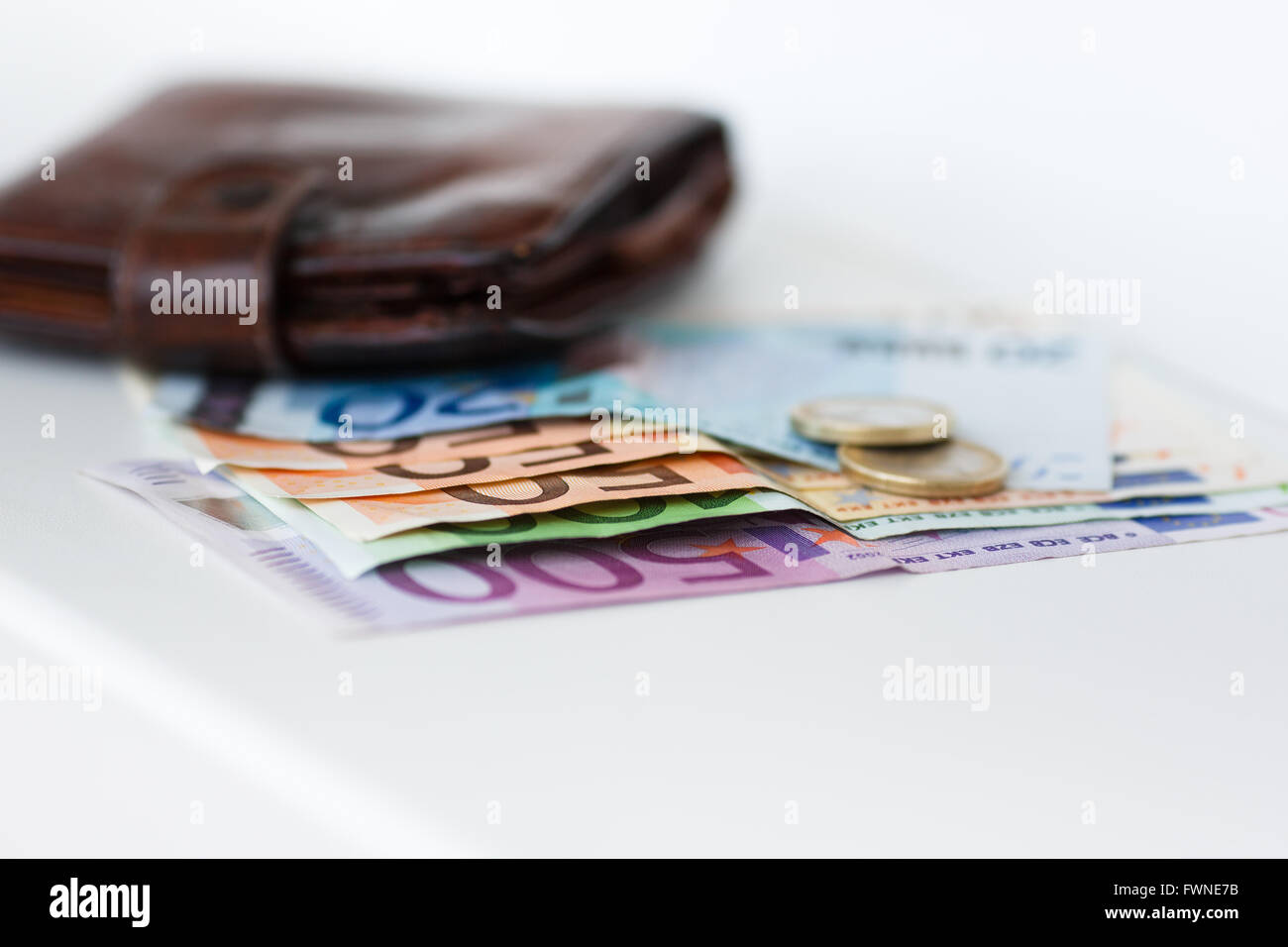 Banknotes, coins and wallet on the white background Stock Photo