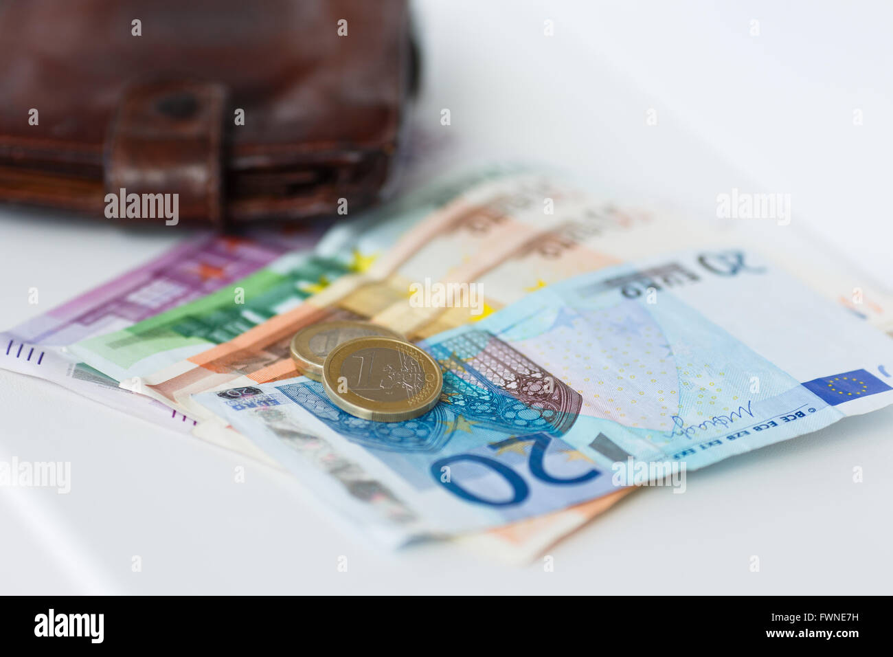 Banknotes, coins and wallet on the white background Stock Photo