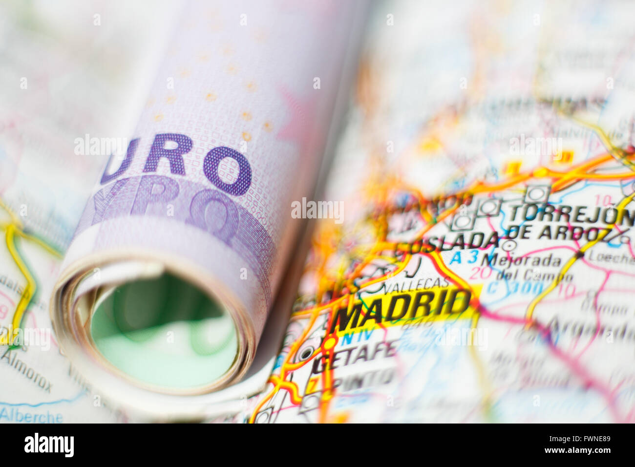Euro banknotes on a geographical map of Madrid, Spain Stock Photo