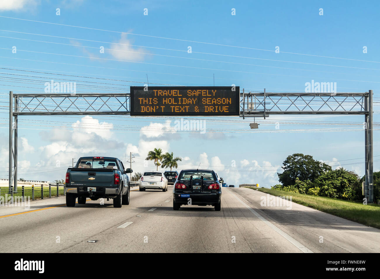 Electronic variable message board on matrix billboard on highway in Florida warning drivers not to text and drive, United States Stock Photo