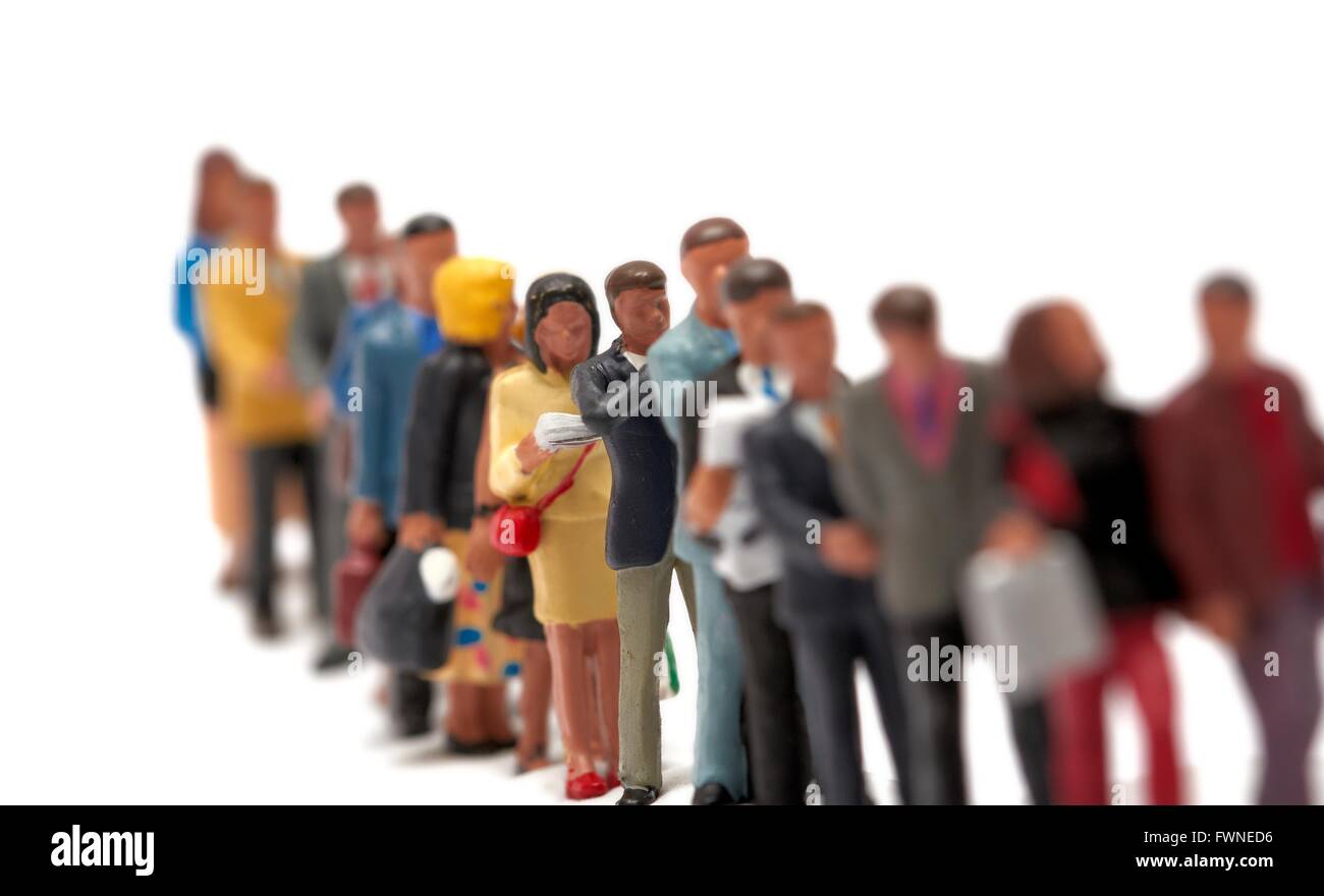 Miniature figure people forming an orderly queue against a white ...