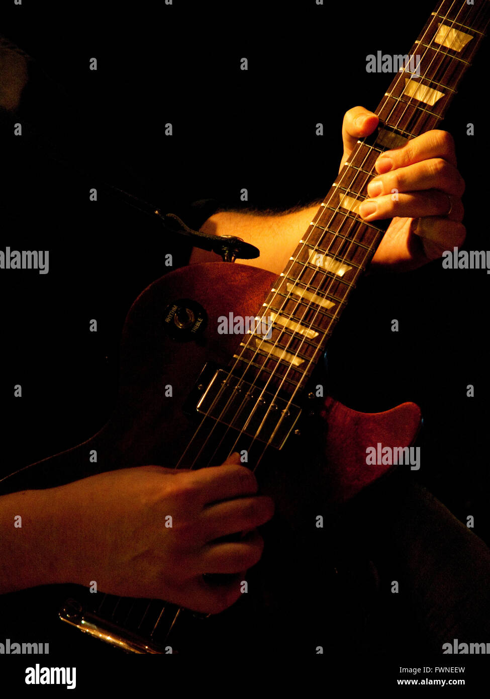 Guitar player hands on fretboard Stock Photo