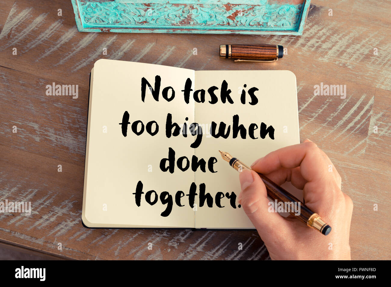 Retro effect and toned image of a woman hand writing on a notebook ...