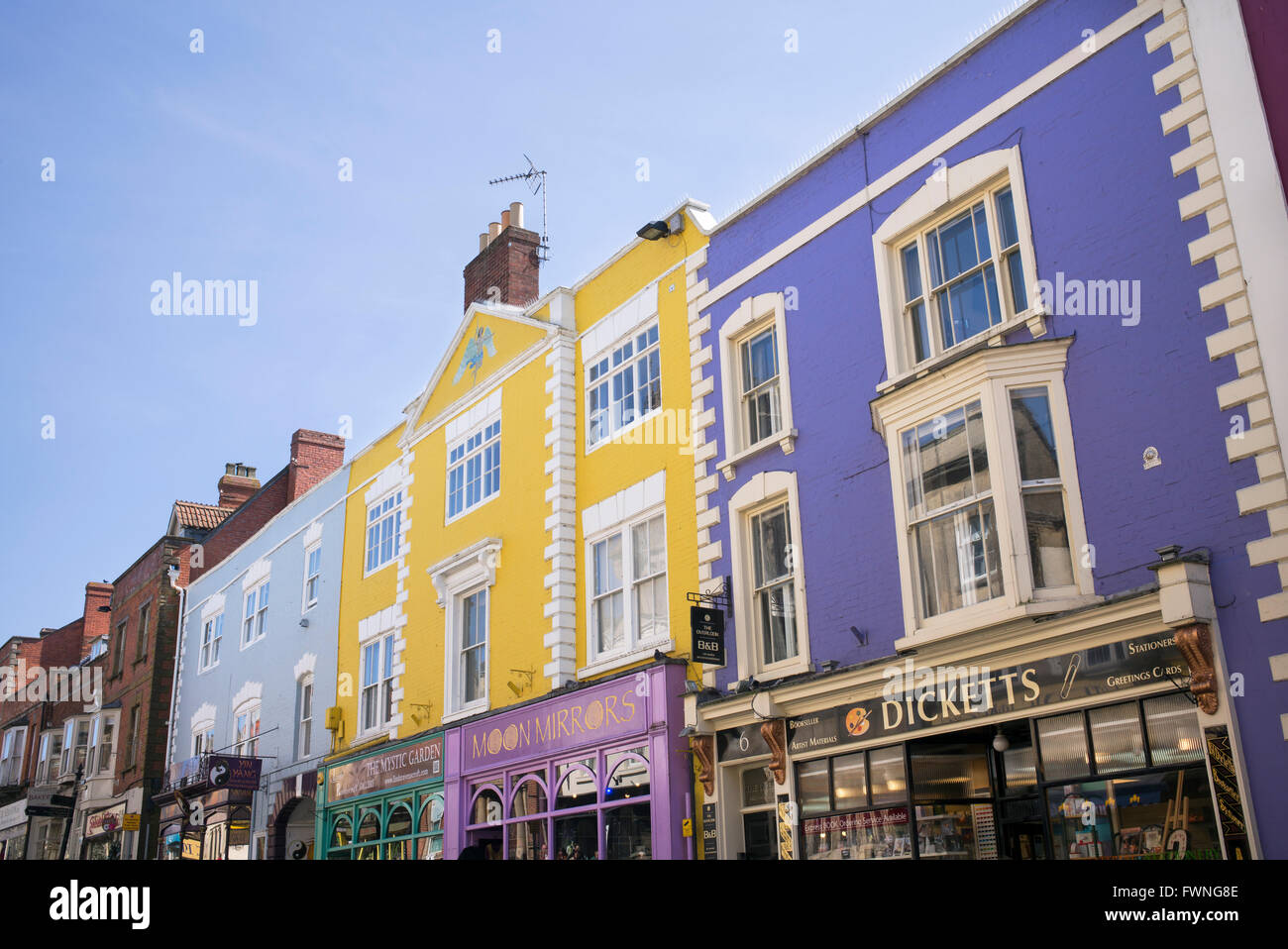 Colourful shop fronts in the high street. Glastonbury, Somerset