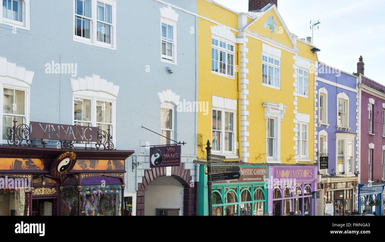 Colourful shop fronts in the high street. Glastonbury, Somerset, England Stock Photo