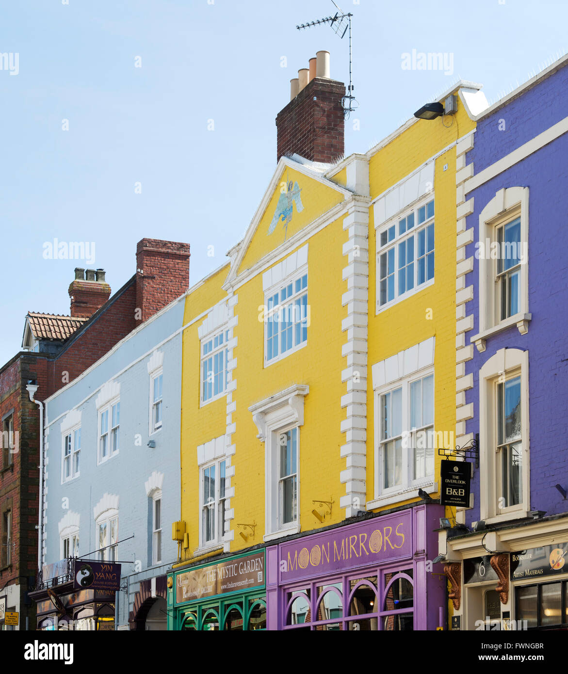 Colourful shop fronts in the high street. Glastonbury, Somerset, England Stock Photo