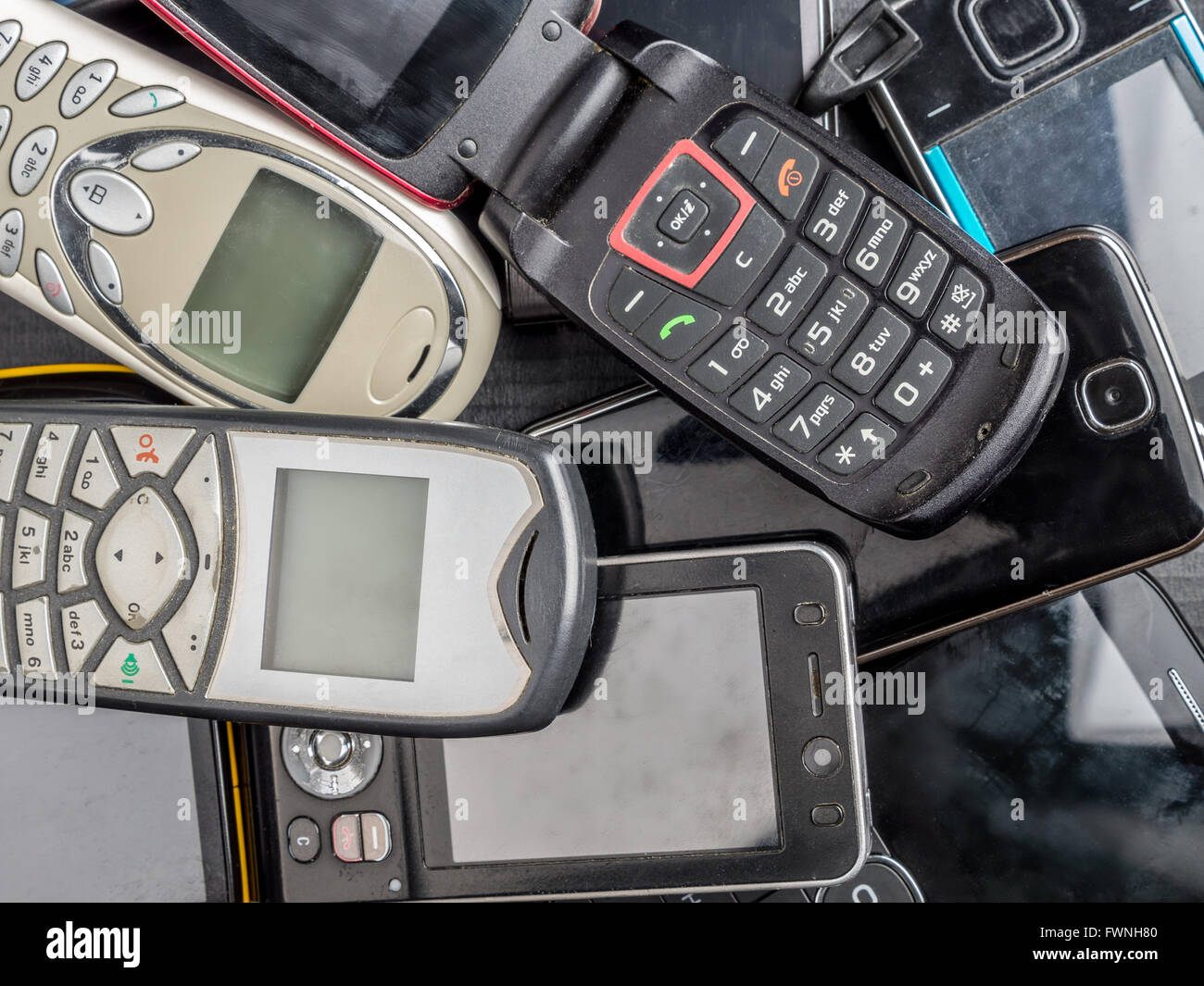 Pile of old and used mobile phones Stock Photo