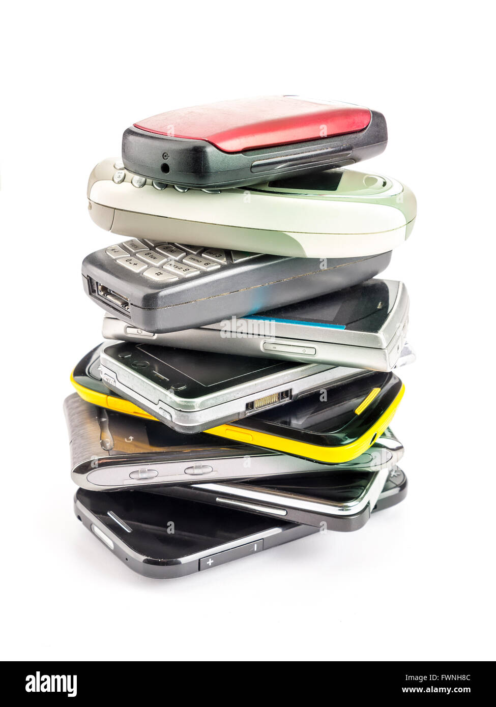 Pile of old and used mobile phones on white background Stock Photo