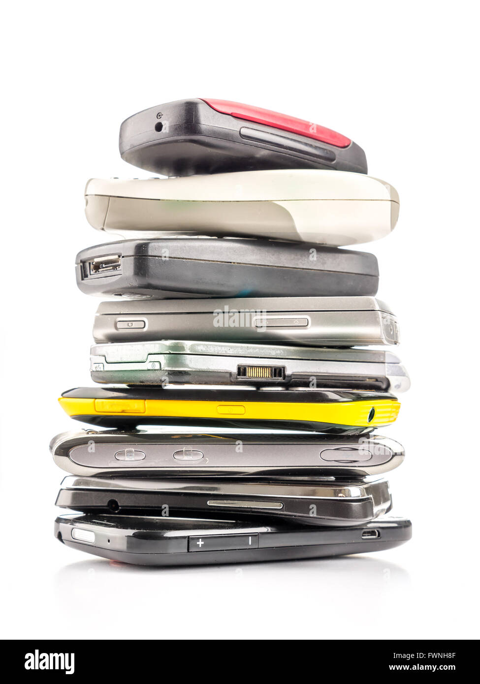 Pile of old and used mobile phones on white background Stock Photo