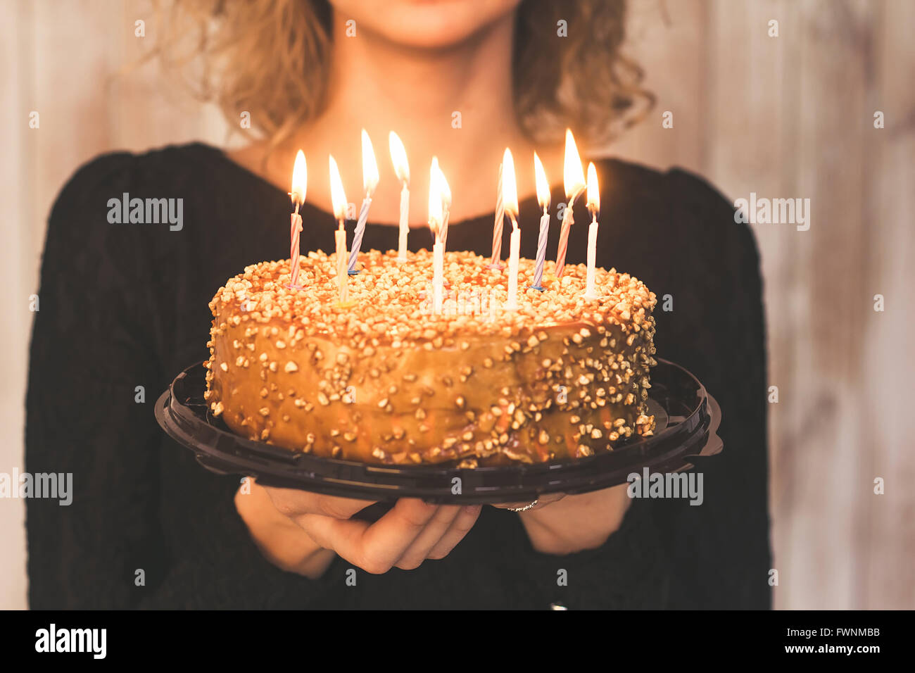 Hands of young woman holding birthday cake selective focus Stock Photo