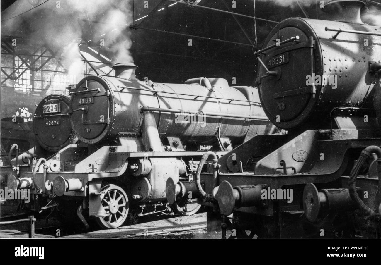 Here an LMS Crab 2-6-0 and two Stanier 8F 2-8-0s back amid the rippled sunlight. Stock Photo