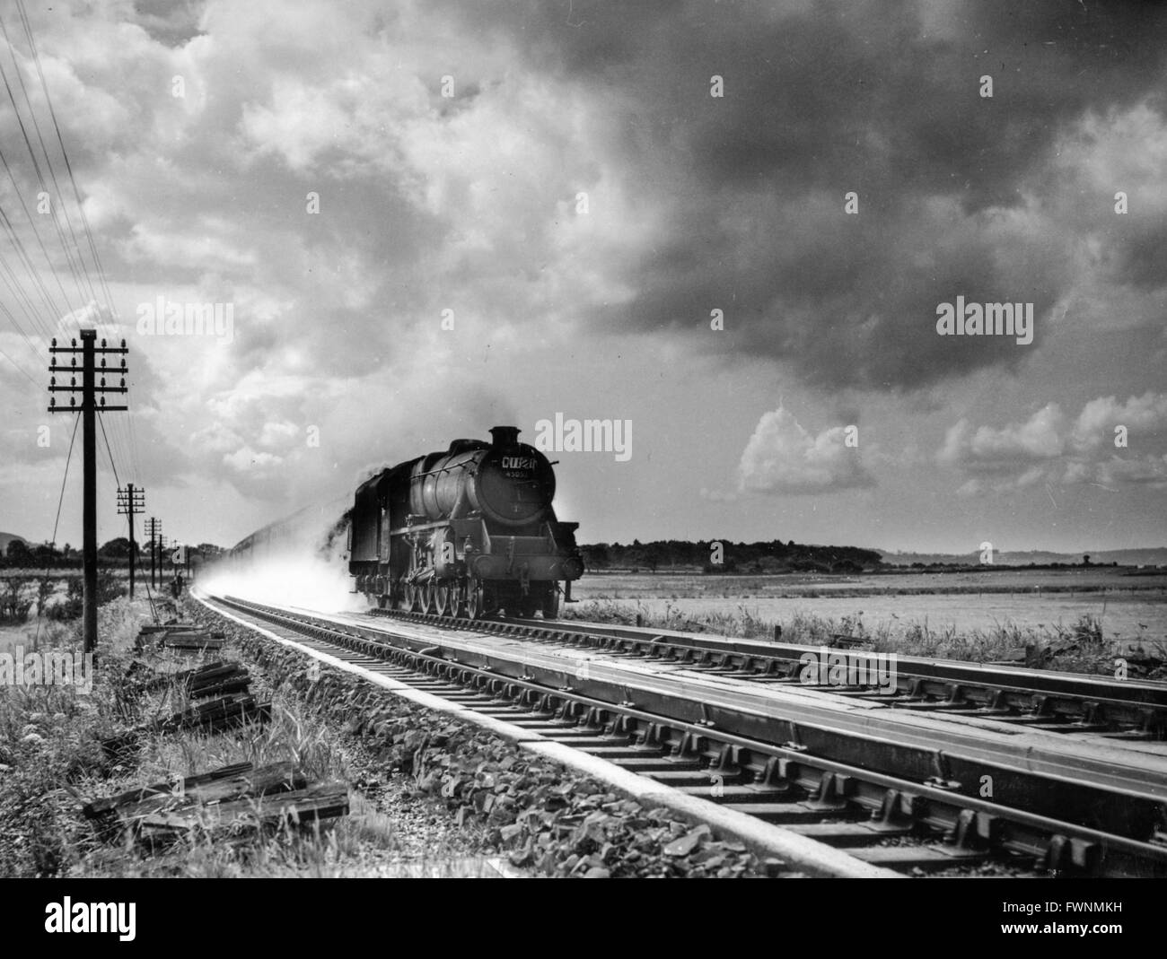 Stanier Black 5 No 5057 picks up water at speed. The location is possibly Dunsmore troughs between Rugby and Nuneaton. Stock Photo
