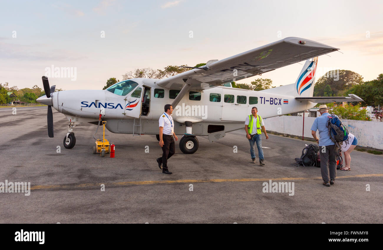 PUERTO JIMENEZ, COSTA RICA - Sansa Airlines airplane arrival, on Osa Peninsula. Cessna Caravan turboprop. Stock Photo