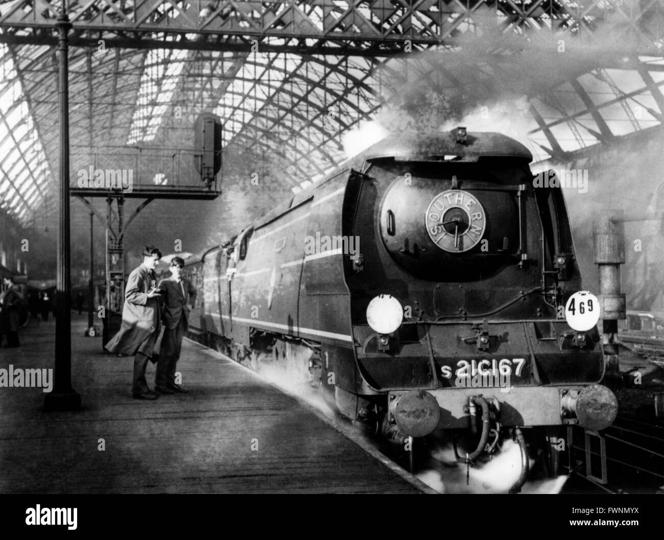 At Cannon street newly built Battle Of Britain Class 4-6-2 No 216167 'Tangmere' heads a down Dover express in the evening rush h Stock Photo