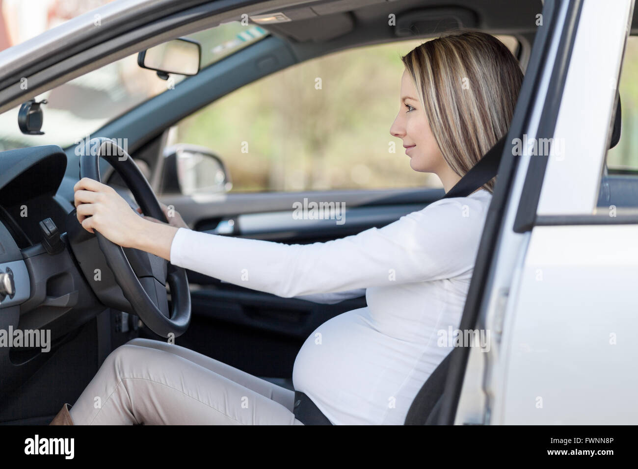 Pregnant woman driving her car, wearing seat belt Stock Photo Alamy