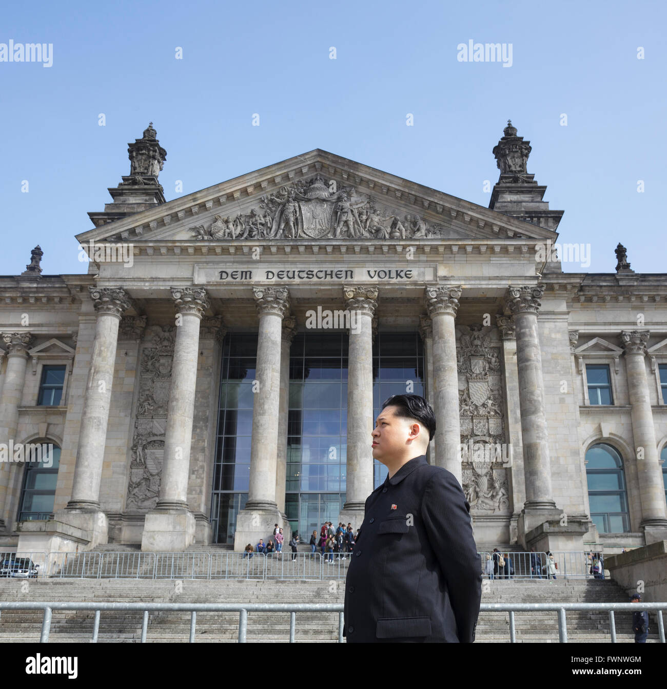 Berlin, Germany. 6th April 2016. Kim Jong Un impersonator, Howard X from Hong Kong, visited Berlin, touring the major tourist sites to the surprise of tourists and locals. Howard was visiting Germany to film an advertisement for the popular German TV show 'Schlag den Star' with comedian Elton.  Here at the Reichstag / Bundestag Stock Photo