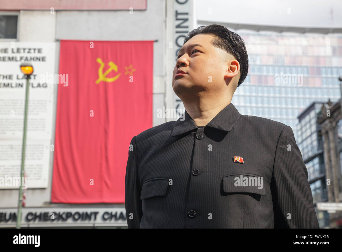 Berlin, Germany. 6th April 2016. Kim Jong Un impersonator, Howard X from Hong Kong, visited Berlin, touring the major tourist sites to the surprise of tourists and locals. Howard was visiting Germany to film an advertisement for the popular German TV show 'Schlag den Star' with commedian Elton.  Here, at Haus am Checkpoint Charlie Museum with the Last Kremlin Flag. Model release available for Howard X. Credit:  Julie Woodhouse/Alamy Live News Stock Photo