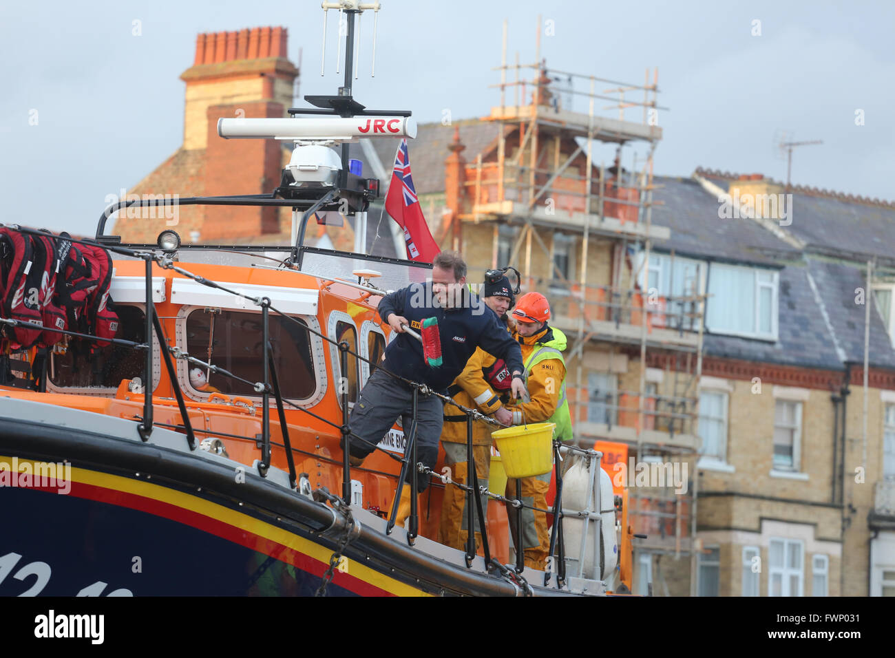 Bridlington, UK. 06th Apr, 2016. RNLI crewmen cleaning the deck of the