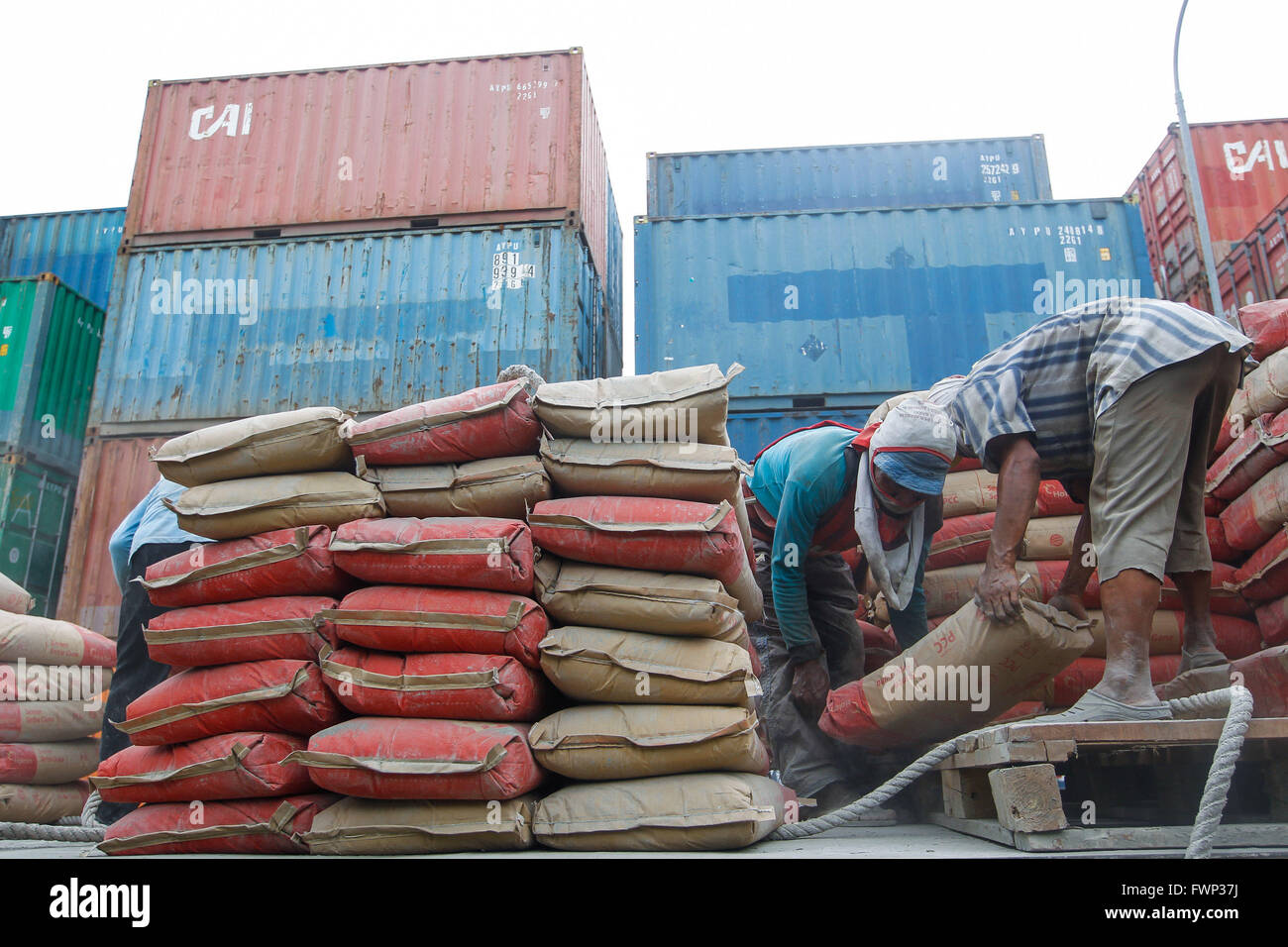 Jakarta, Indonesia. 30th Mar, 2016. Workers arrange sacks of cement