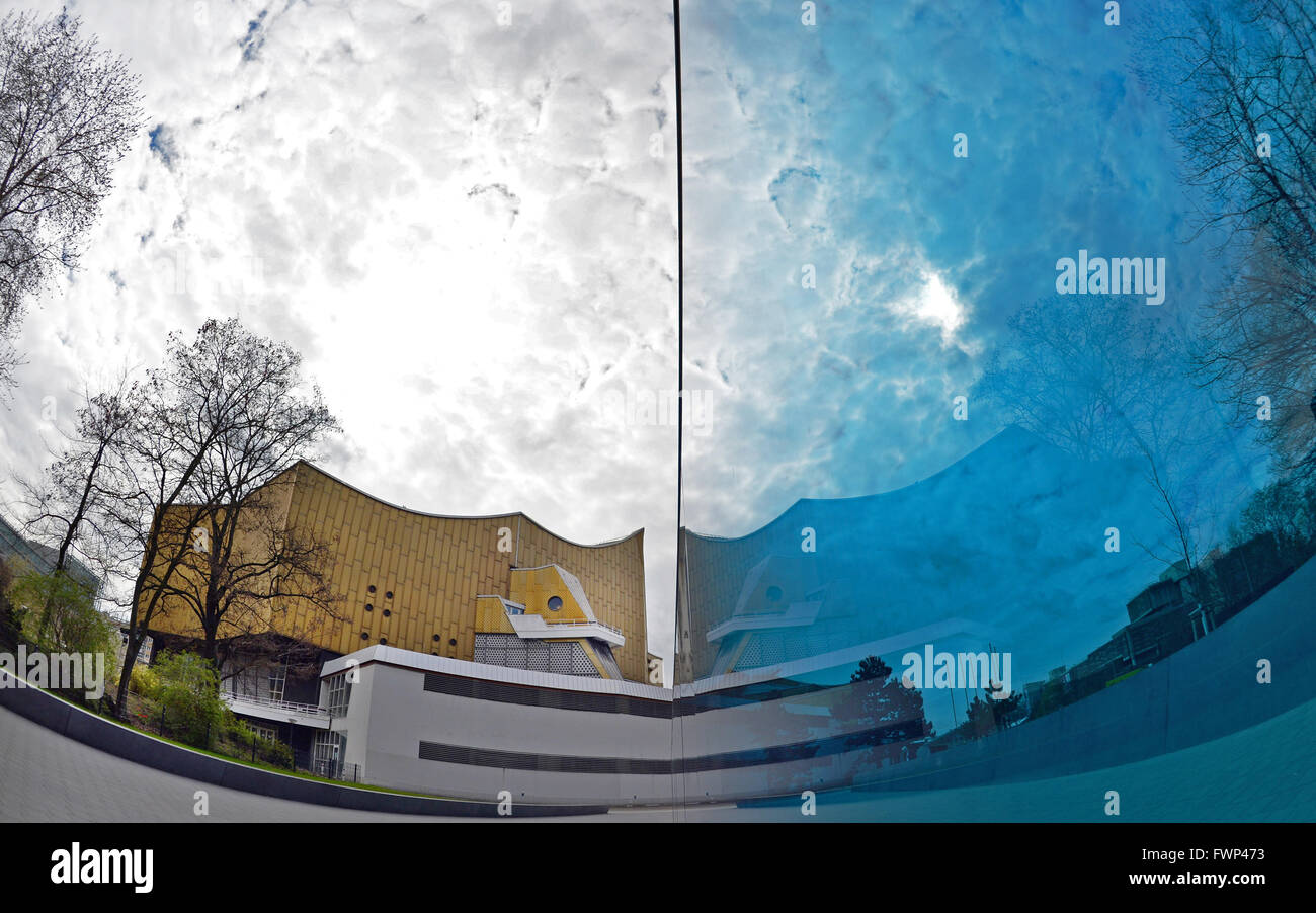 Berlin, Germany. 07th Apr, 2016. The philharmonic is reflected in the blue glass wall of the memorial to the victims of the National Socialist 'euthanasia' murders in Berlin, Germany, 07 April 2016. Photo: PAUL ZINKEN/dpa/Alamy Live News Stock Photo