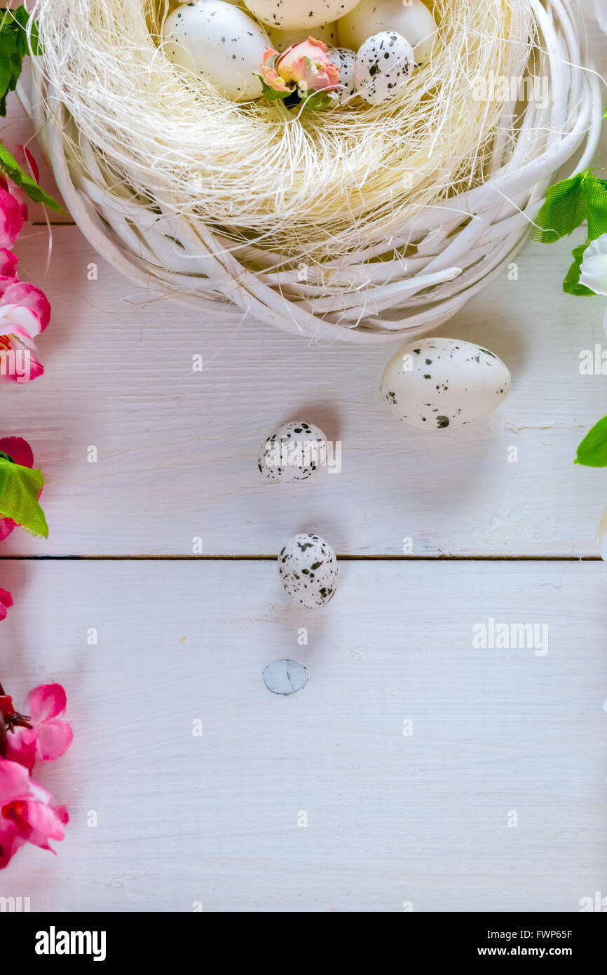 Beautiful Easter background with flowers and nest with eggs on the ...