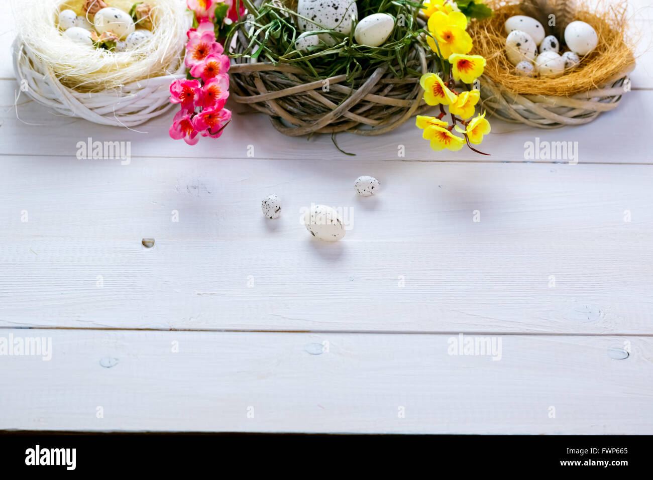 Beautiful Easter background with flowers and nest with eggs on the ...