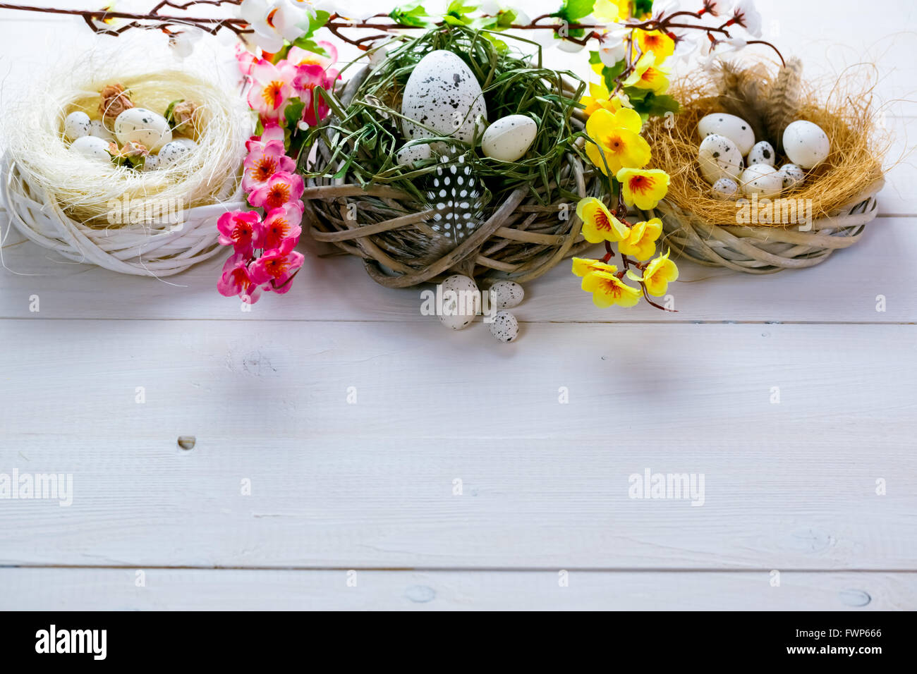 Beautiful Easter background with flowers and nest with eggs on the ...