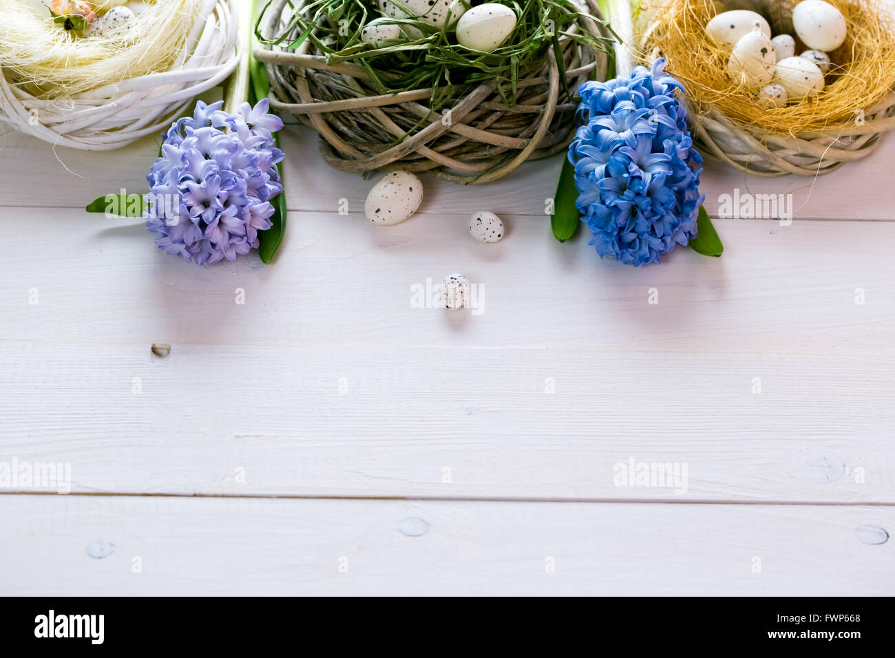 Beautiful Easter background with flowers and nest with eggs on the ...