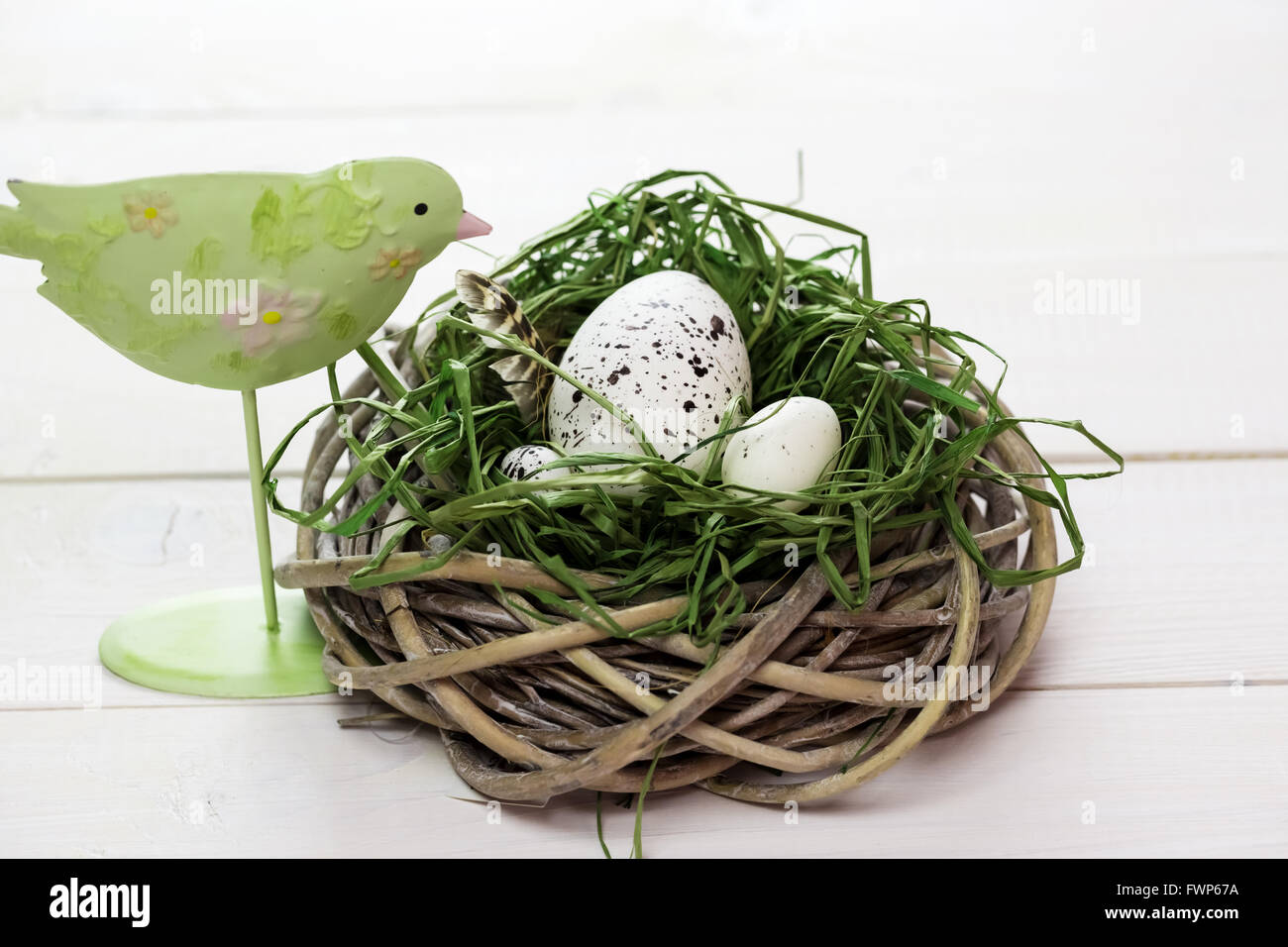 Beautiful Easter background with bird and nest with eggs on white painted boards Stock Photo
