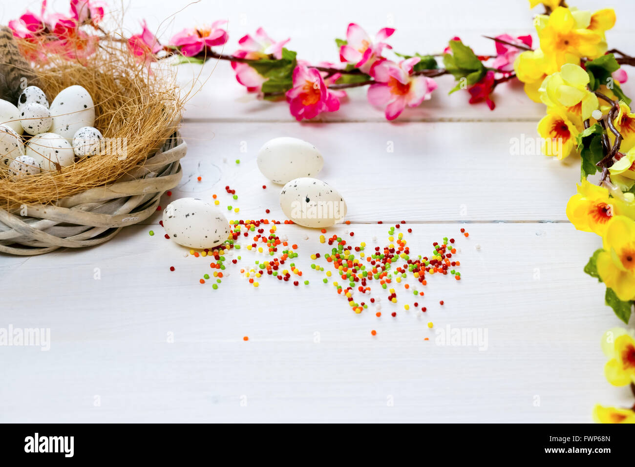 Beautiful Easter background with flowers and nest with eggs on white ...