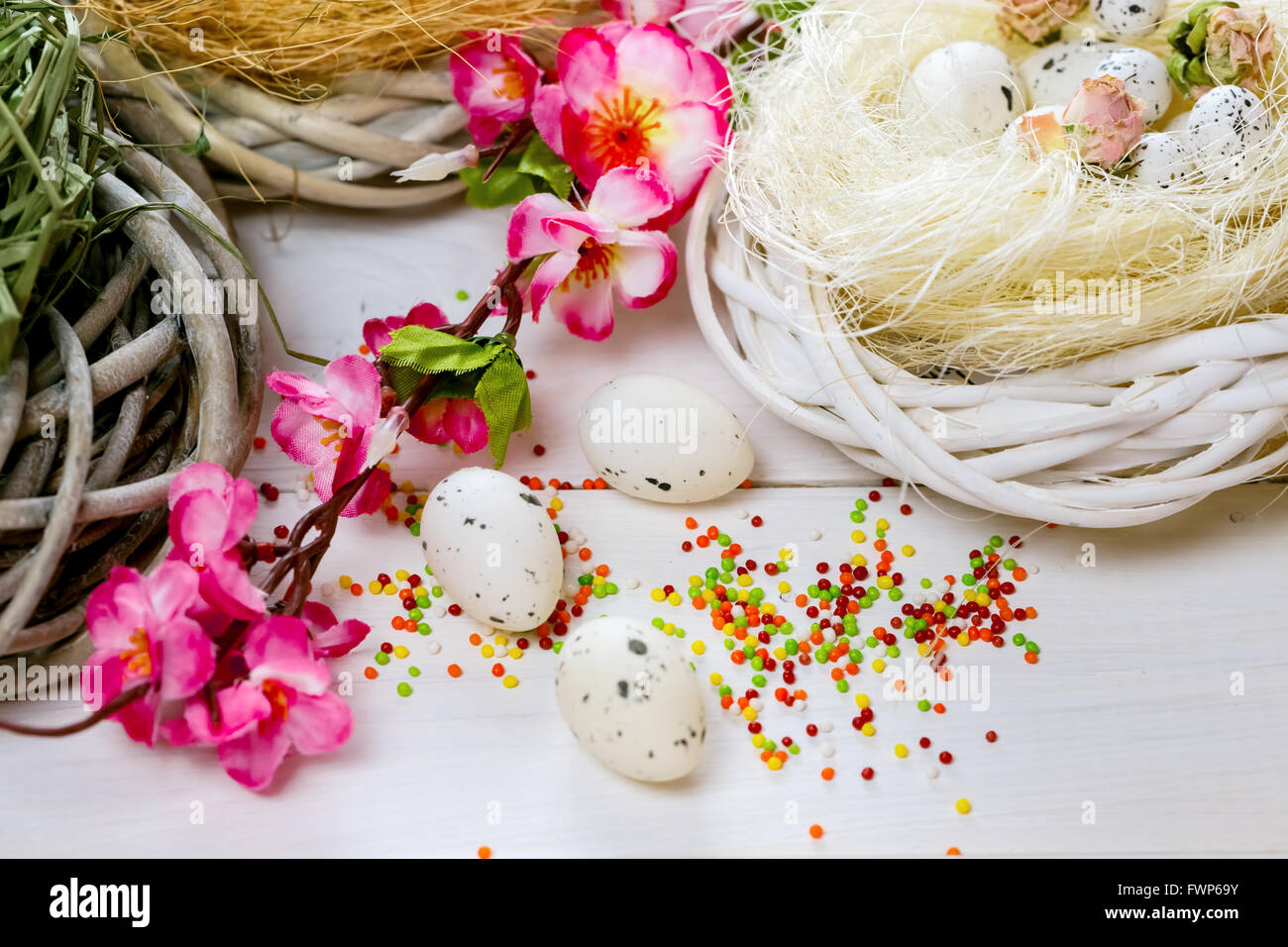 Beautiful Easter background with flowers and nest with eggs on white ...