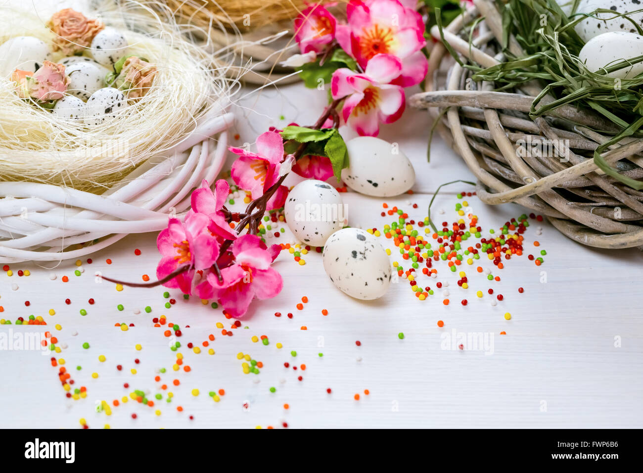 Beautiful Easter background with flowers and nest with eggs on white ...