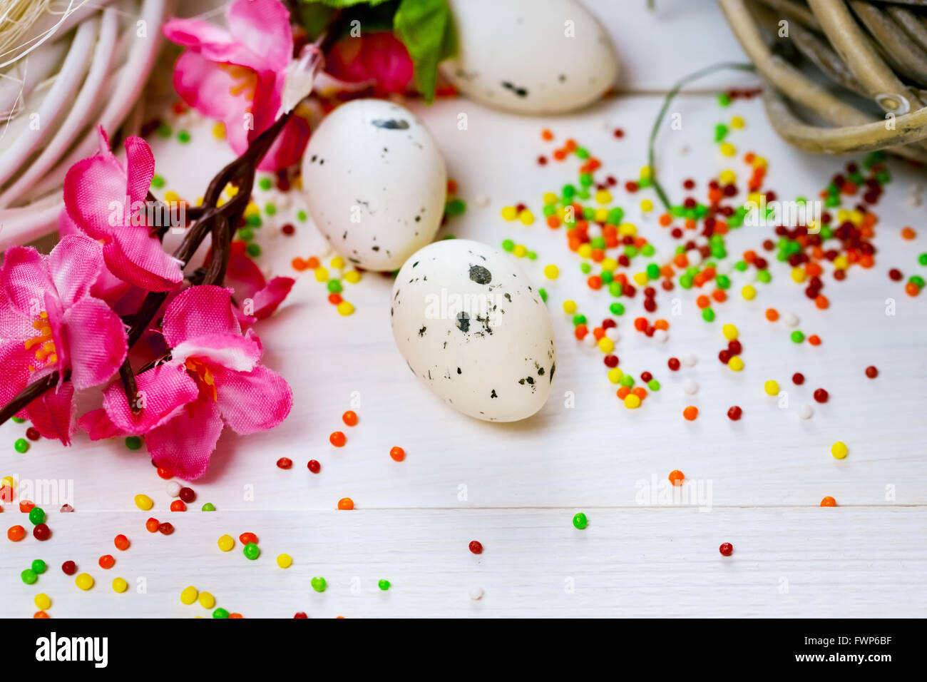 Beautiful Easter background with flowers and nest with eggs on white ...