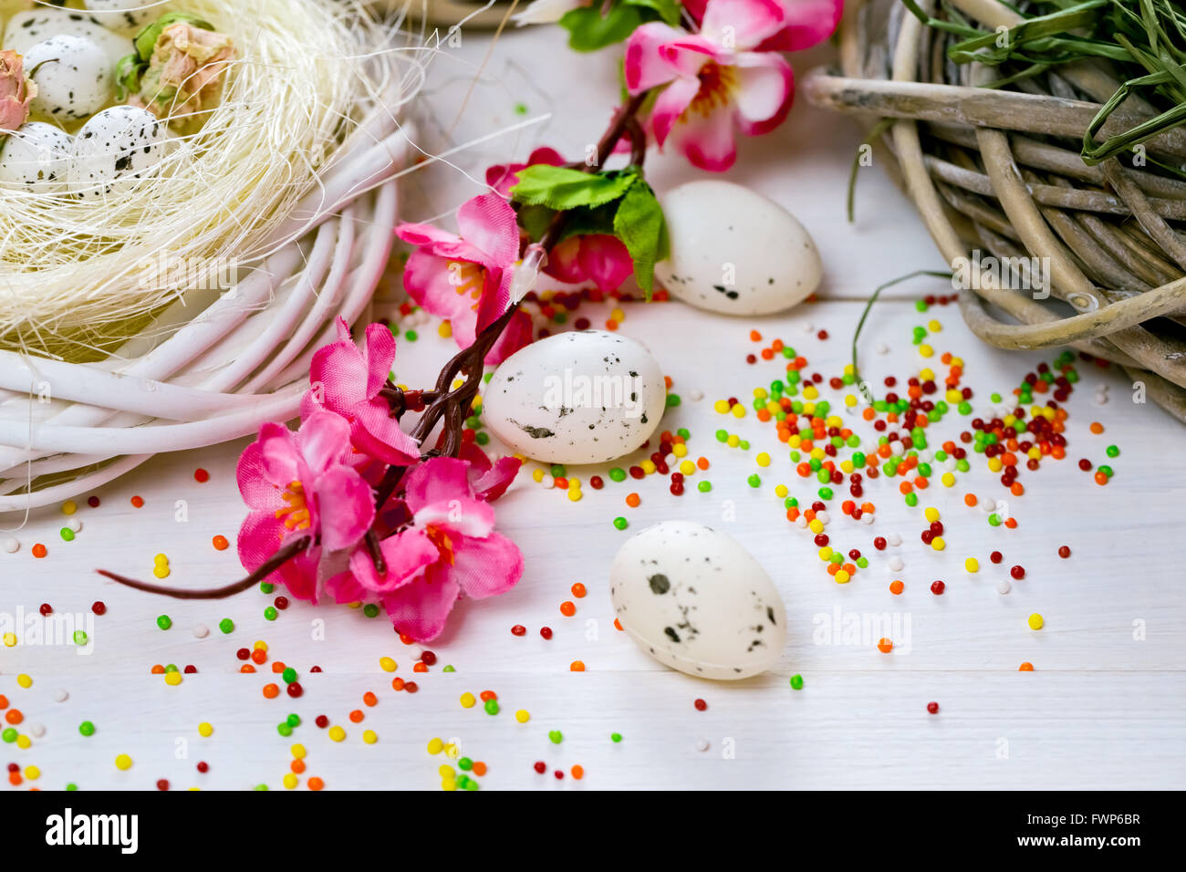 Beautiful Easter background with flowers and nest with eggs on white ...