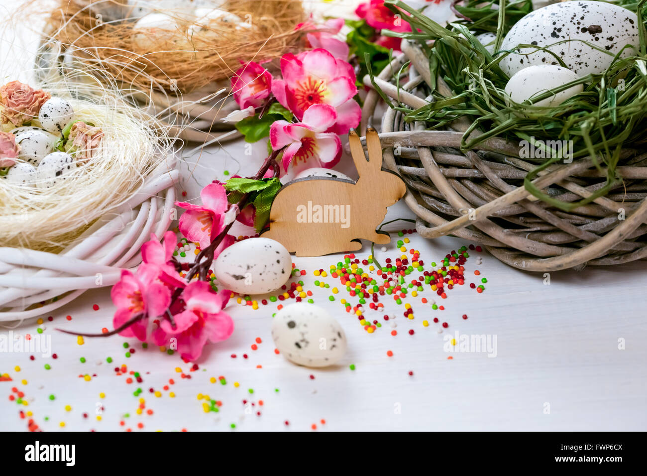 Beautiful Easter background with flowers and nest with eggs on white ...