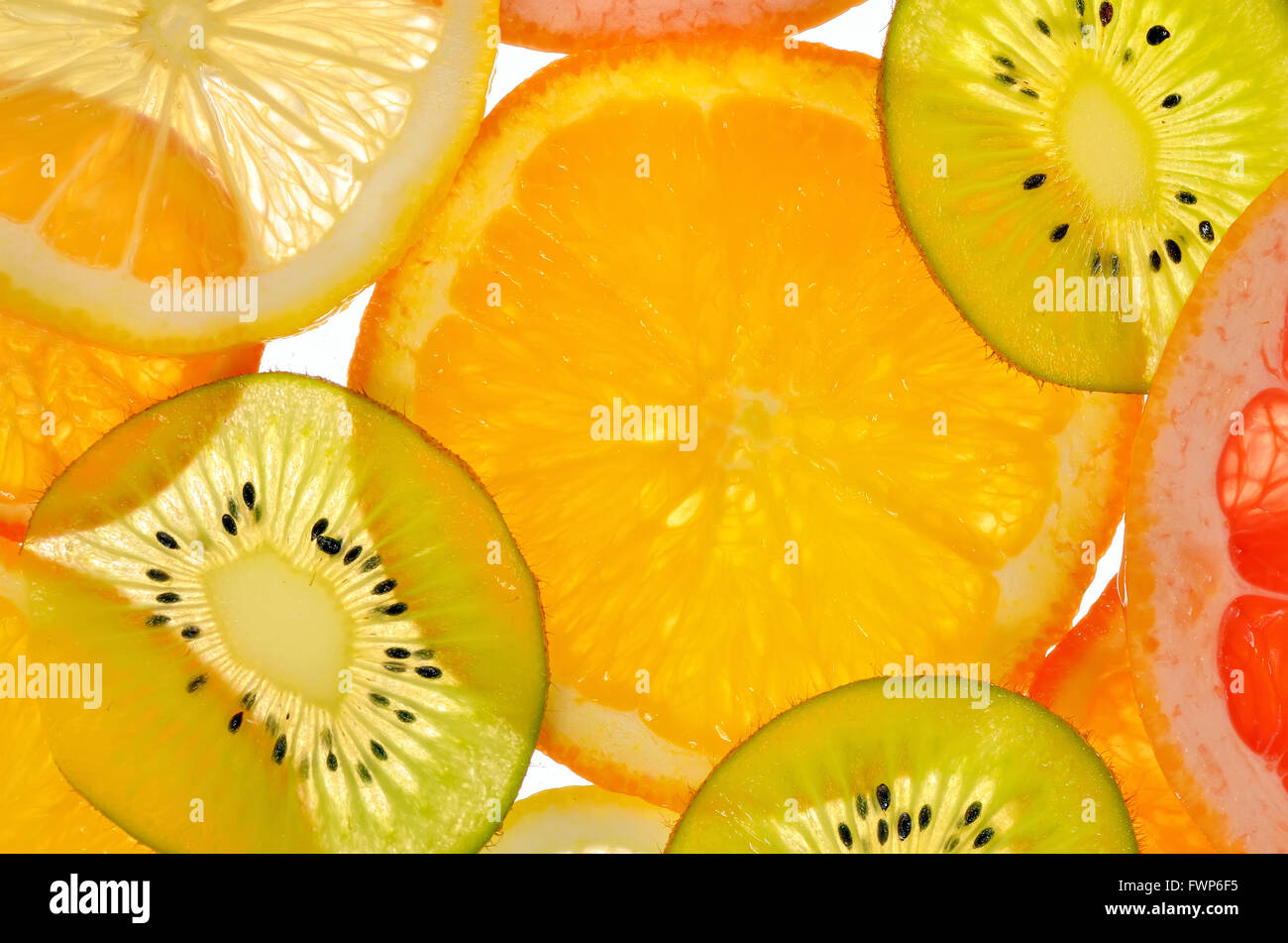 Different sliced juicy citrus fruits Stock Photo