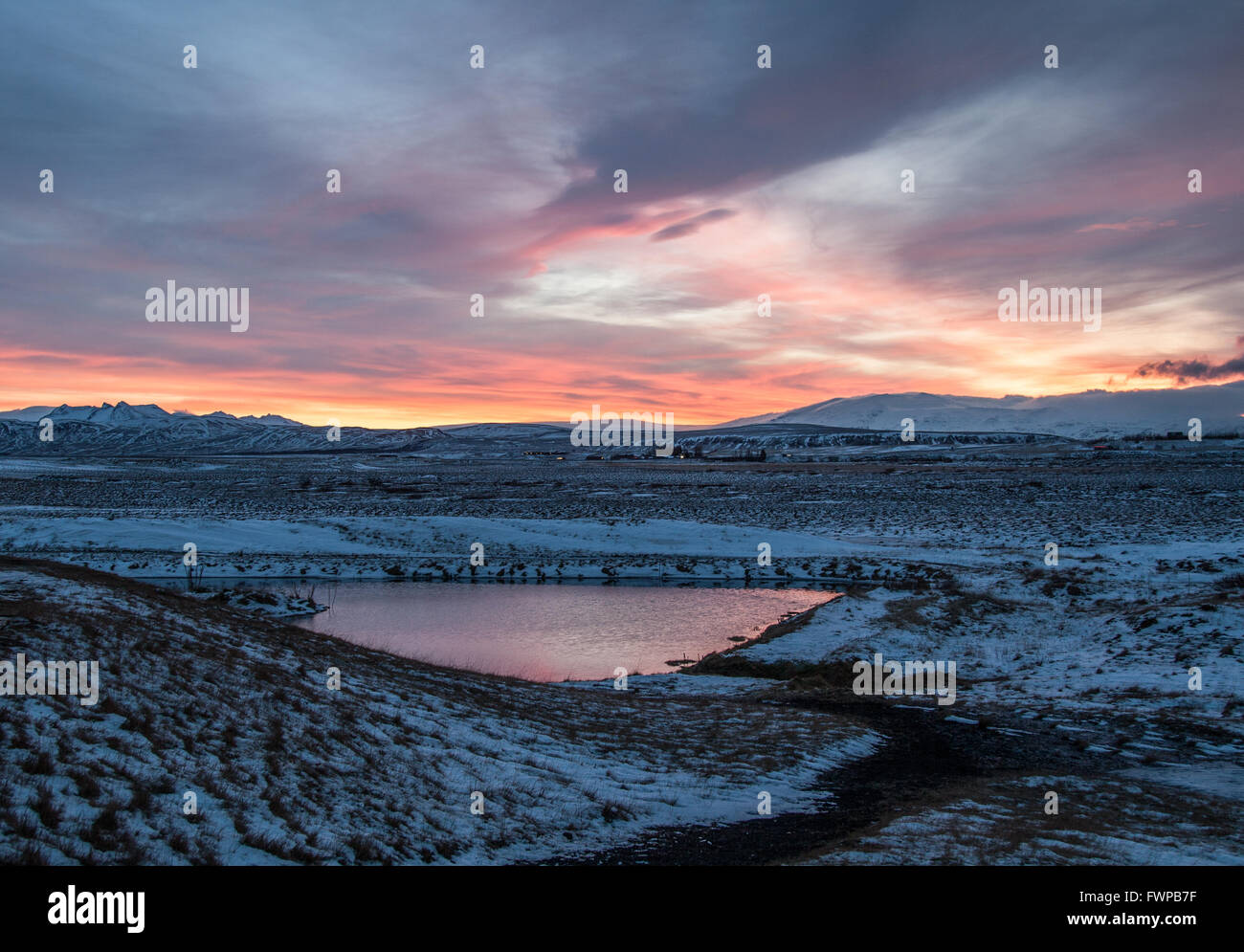 Winter sunrise at Hotel Ranga, Hella, Iceland reflected in lake Stock Photo