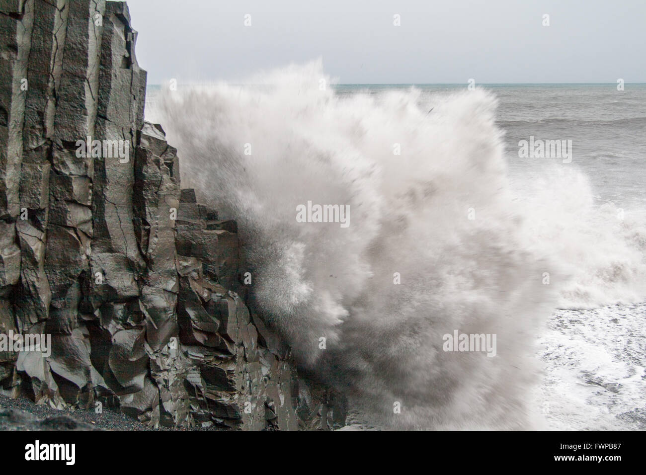 Waves crashing against basalt columns at Reynisfjara beach, near Vik Stock Photo