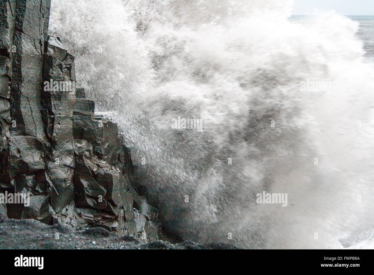 Close up of waves crashing against basalt columns at Reynisfjara beach, near Vik Stock Photo