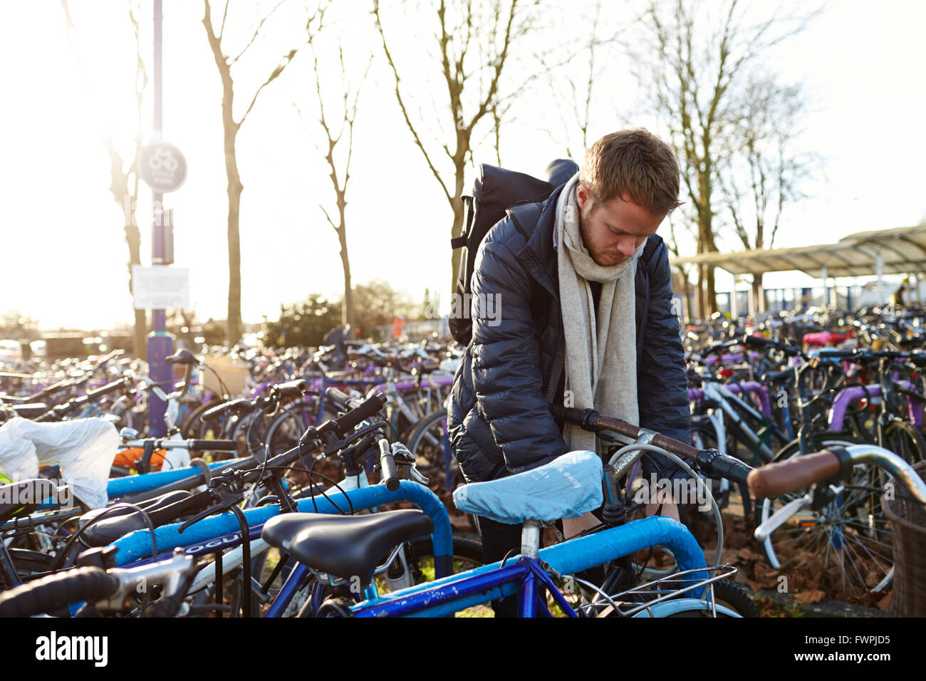 Man Leaving Bike In Cycle Park At Railway Station Stock Photo Alamy